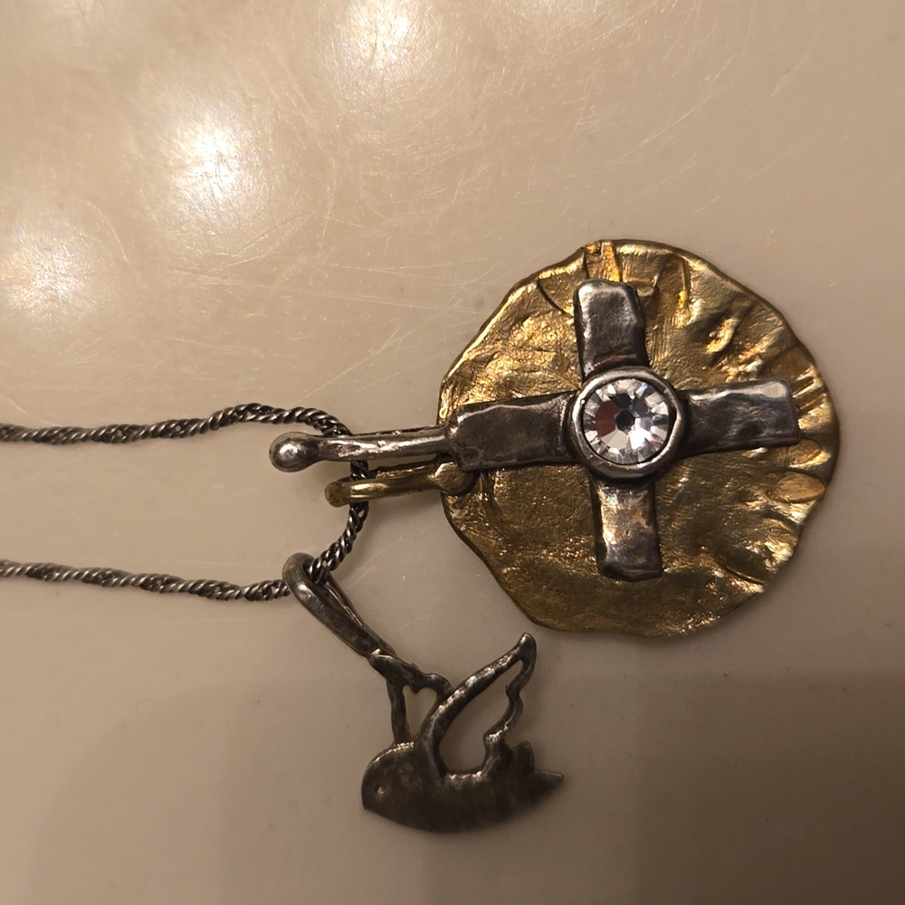 Silpada Sterling Silver necklace with a cross, dove charms, and gold circle.